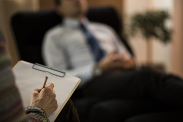 Wall Mural - Close-up of psychotherapist writing diagnose