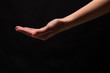 © Prostock-studio - Woman holding palm open isolated on black