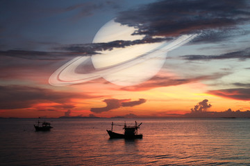 Wall Mural - Saturn back on night cloud sunset sky silhouette boat on sea
