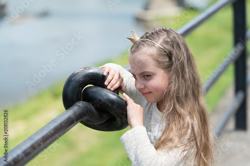 Girl Kid On Smiling Face With Tiny Golden Crown On Head Riverside