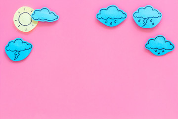Wall Mural - weather forecast concept. modern weather icons set on pink background top view copy space
