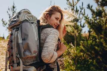 Wall Mural - woman with backpack hiking in nature