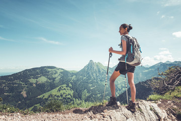 healthy fit young woman hiker on a mountain summit