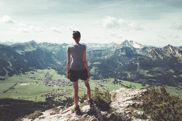 Wall Mural - healthy fit young woman hiker on a mountain summit