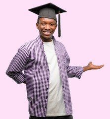 Poster - Young african graduate student black man confident and happy with a big natural smile inviting to enter