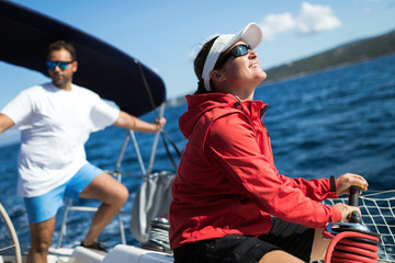 Canvas Print - Attractive strong woman sailing with her boat