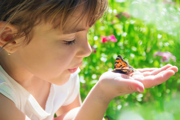 Child with a butterfly. Selective focus.