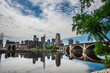 Minneapolis skyline reflects into a mirror-like Mississippi River