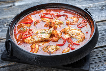 Wall Mural - Traditional Creole cajun court bouillon with fish and seafood gumbo chowder stew as top view in a pot