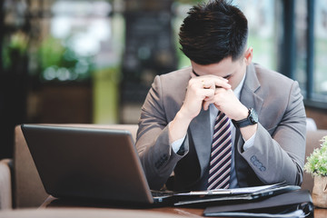 Young employee looking at computer monitor during working day in office