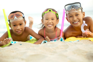 Wall Mural - Asian kids playing on the beach.