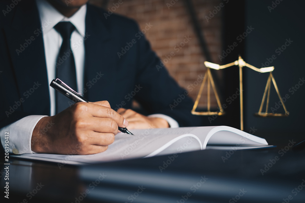Close up lawyer businessman working or reading lawbook in office workplace for consultant lawyer concept. - obrazy, fototapety, plakaty 