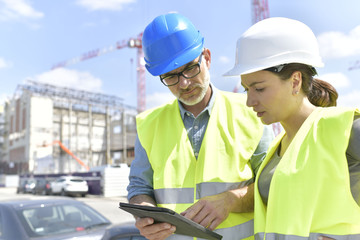 construction manager and engineer working on building site