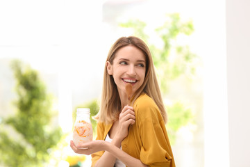 Poster - Young attractive woman eating tasty yogurt, indoors