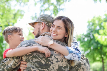 Wall Mural - Male soldier with his family outdoors. Military service