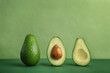 Composition with ripe avocados on color background