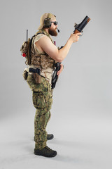 Wall Mural - Special forces soldier with rifle on white background.