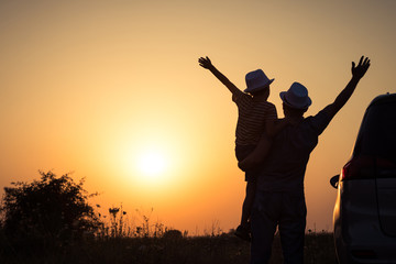 Wall Mural - Father and son playing in the park at the sunset time.