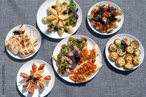 Plates With Snacks On Servered Buffet Table At Wedding Reception