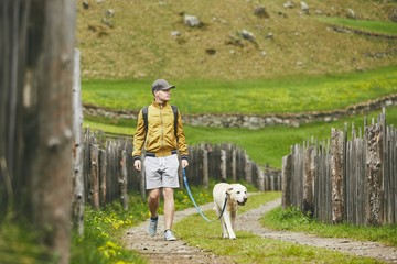 Wall Mural - Tourist with dog in countryside