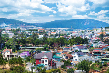 Wall Mural - Beautiful houses with in the Da Lat city (Dalat) on the blue sky background in Vietnam. Da Lat and the surrounding area is a popular tourist destination of Asia.