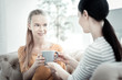 © Viacheslav Yakobchuk - Camomile tea. Female psychologist giving tea to adorable pretty teen girl while conducting therapy and chatting with her