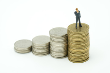 Miniature people businessmen standing Investment Analysis Or investment stack of coins to thinking and planning.as background business concept with copy space.