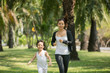 © nareekarn - Mom and child run in the park