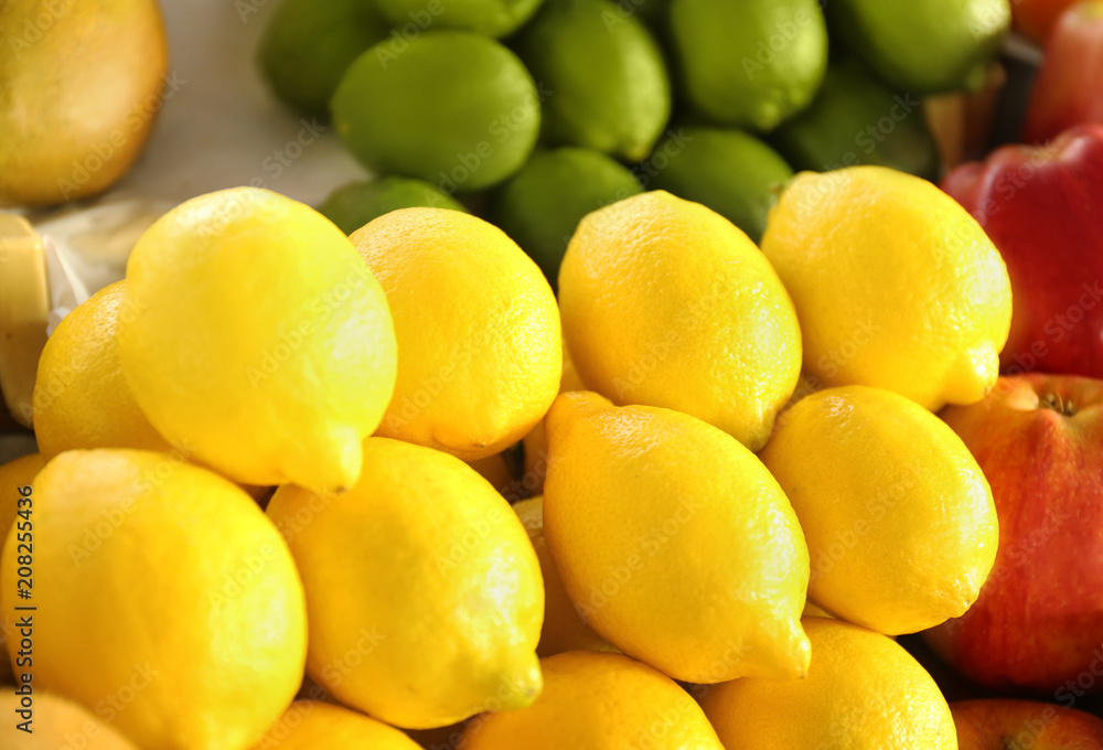 Many ripe lemons on market counter. Fresh citrus fruit