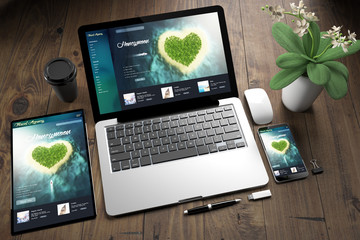 Wall Mural - tablet, laptop and mobile phone over wooden desktop showing honeymoon website