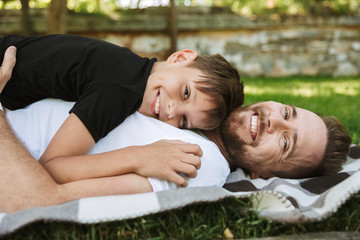 Wall Mural - Happy young father with his little son