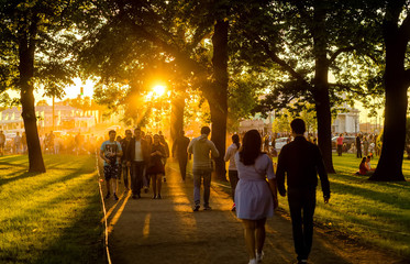 at sunset, people spend the weekend with the whole family in the park. sunset family weekend.