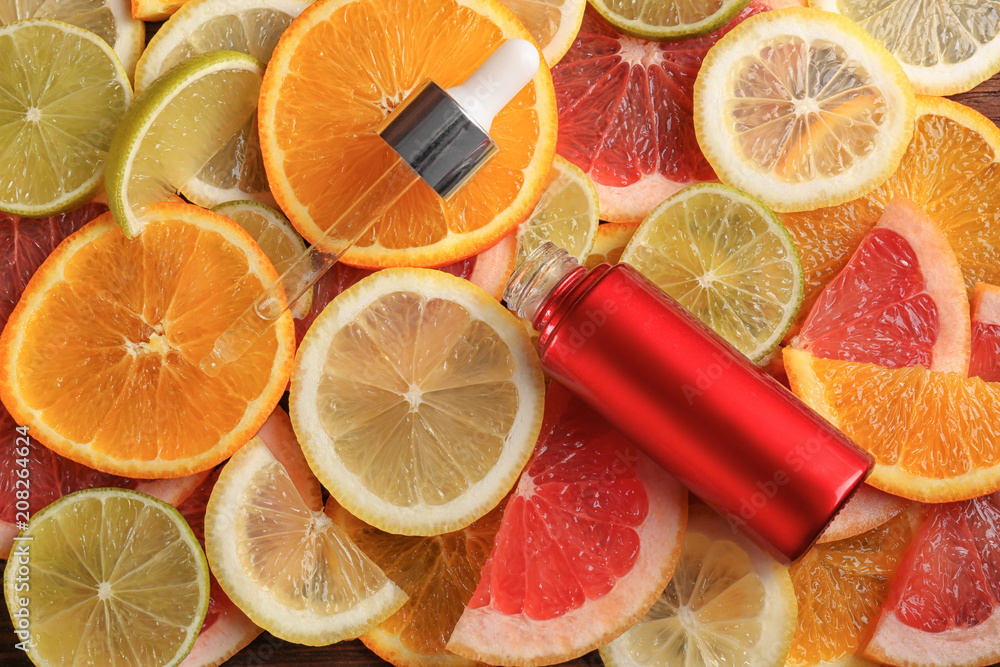 Bottle of essential oil on citrus slices