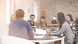 © Pixel-Shot - Young people having business meeting in conference room, view through glass