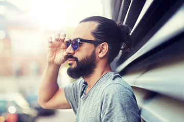 Sticker - lifestyle, emotion, expression and people concept - happy smiling man with sunglasses and beard on city street