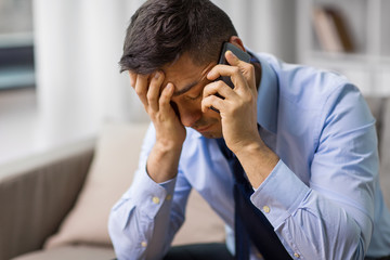 Wall Mural - stress, crisis and people concept - unhappy man calling on smartphone