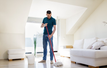 Canvas Print - household, housework and people concept - happy man with mop and bucket cleaning floor at home