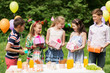© Syda Productions - holidays, childhood and celebration concept - happy kids with gifts on birthday party at summer garden