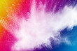 Throwing white particle splash on background. Bizarre forms of of white powder explode on cloud against colorful background.  Holi powder festival.