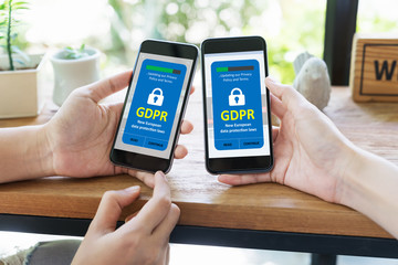 GDPR concept. Data protection laws and regulation or cyber security and privacy. Close up two asian hands using smart phone to accept User's agreement of new privacy policy in mobile application.