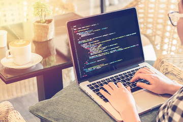 a programmer typing source codes in a coffee shop with a relaxing working environment. studying, wor
