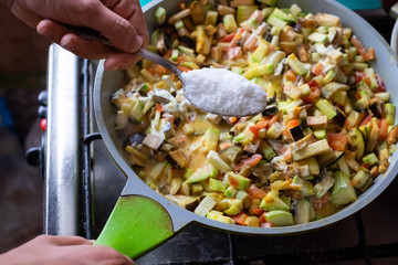 Cooking vegetarian meal. Putting too much salt in vegetables