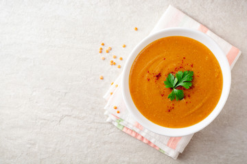 Wall Mural - Red lentil cream soup on gray stone background