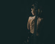 © Volodymyr - Girl with nude back stand with guitar neck as spine, black background. Lady guitarist with sexy appearance naked. Rock star concept. Girl nude and sexy enjoy rock and roll lifestyle, rear view