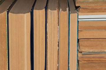 Wall Mural - background, defocusing. Old books neatly stacked on the shelf