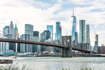 Wall Mural - East river with view of NYC New York City cityscape skyline and bridge, people, boat ship ferry from Brooklyn Bridge park