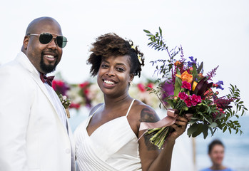 African American couple getting married at the beach