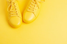 Pair Of Yellow Shoes On Yellow Background. Trendy Summer Color, Monochrome Image. Hipster Concept. Shot At Angle.