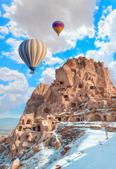 Hot air balloon flying over rock landscape at Cappadocia Turkey