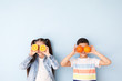 © Pixel-Shot - Funny little children with citrus fruit on color background
